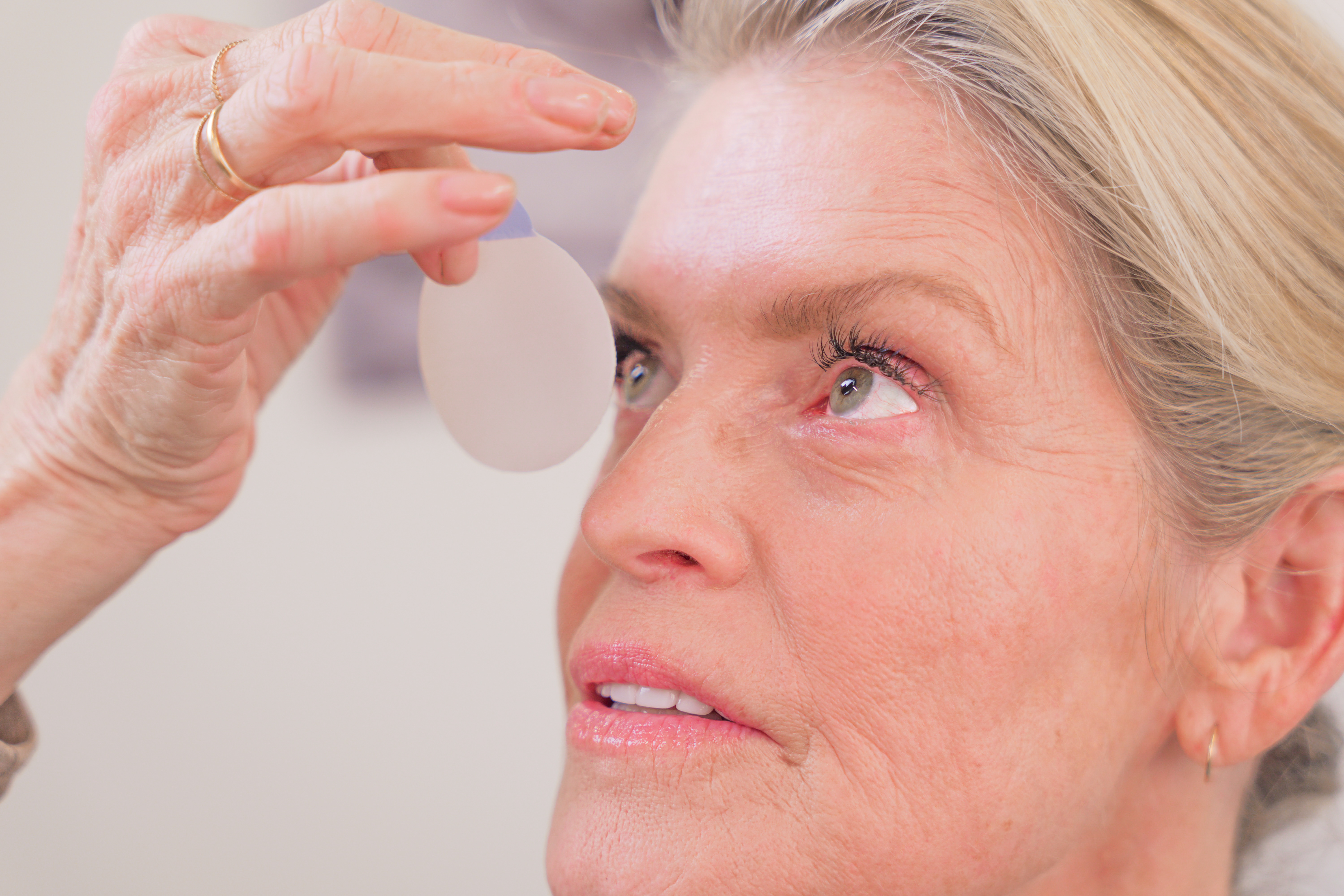 A woman in her late 40s caring for her eyes at the end of the day